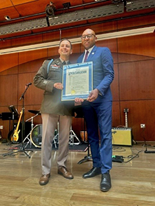 The Hon. Donovan Richards presents LTC Rhodes with the proclamation The Hon. Donovan Richards presents LTC Rhodes with the proclamation