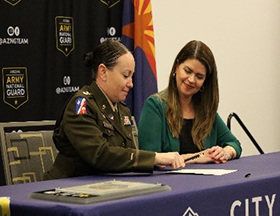 LTC Wiggins and Mayor Romero signing the agreement LTC Wiggins and Mayor Romero signing the agreement